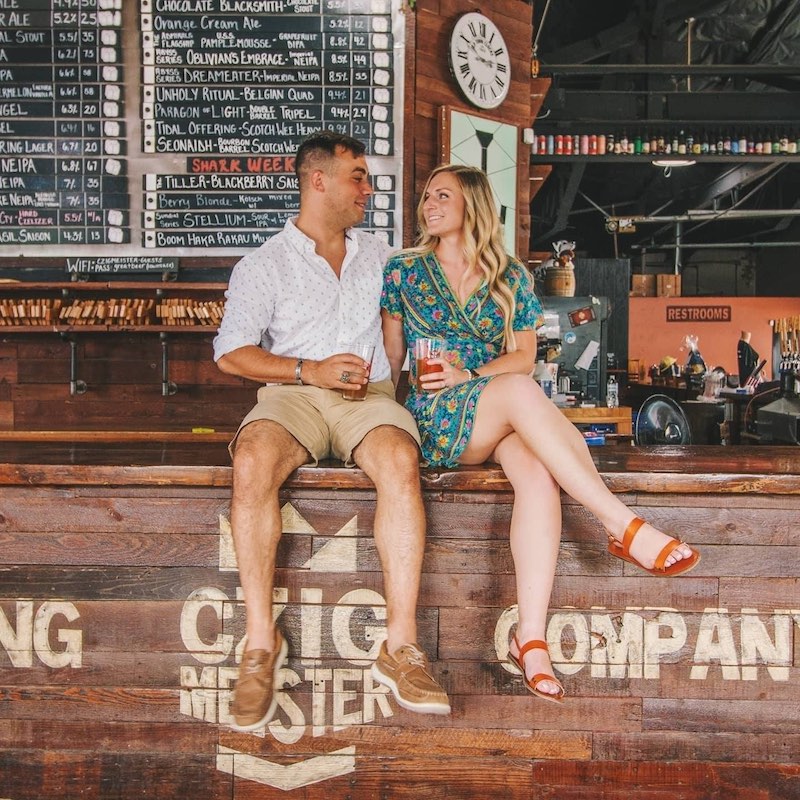 Engaged couple sitting on the bar at Czig Meister brewing. Engaged couple sitting on the bar at Czig Meister brewing.